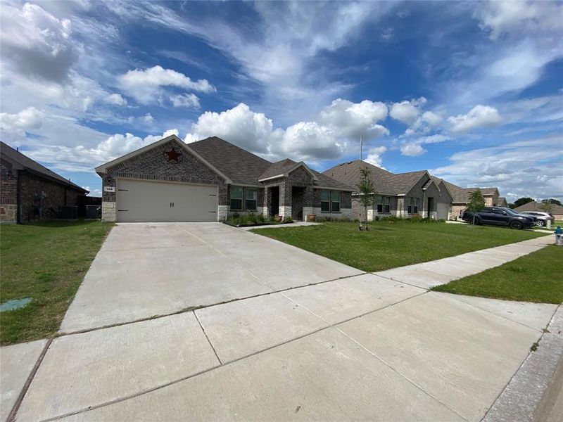 Front exterior of a new home in Stonehaven, Caddo Mills, TX, highlighting curb appeal (Image 10). Front exterior of a new home in Stonehaven, Caddo Mills, TX, highlighting curb appeal (Image 10).