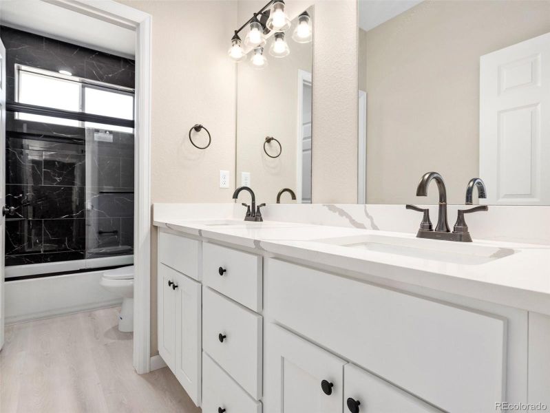 Main bath with double sink quartz vanity and a tub/shower Main bath with double sink quartz vanity and a tub/shower