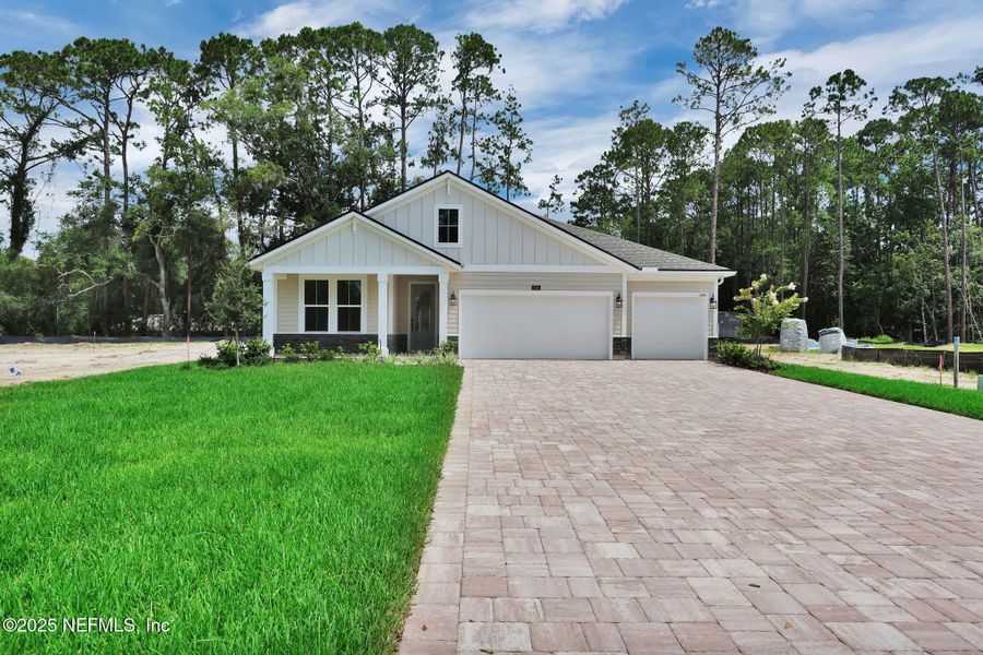 Front exterior of a new home in Creighton Pointe, Fleming Island, FL, highlighting curb appeal (Image 24). Front exterior of a new home in Creighton Pointe, Fleming Island, FL, highlighting curb appeal (Image 24).