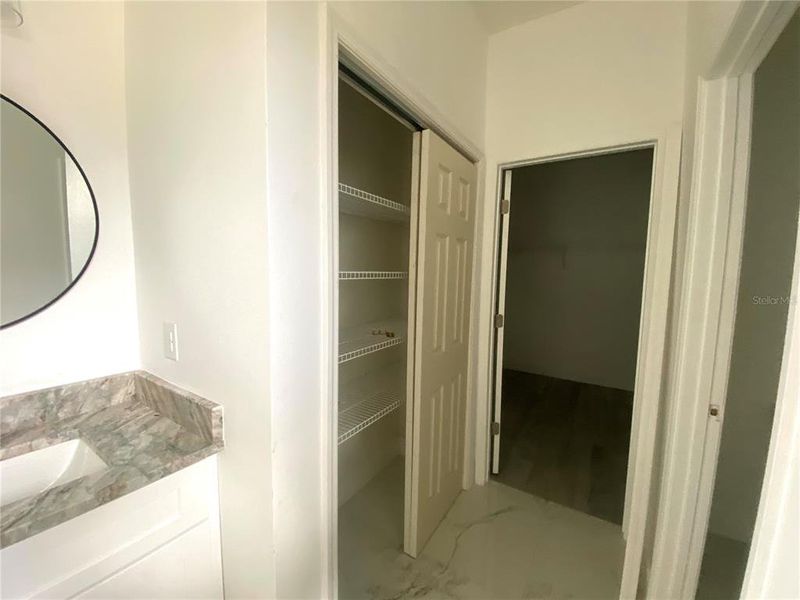 master bath with lien closet