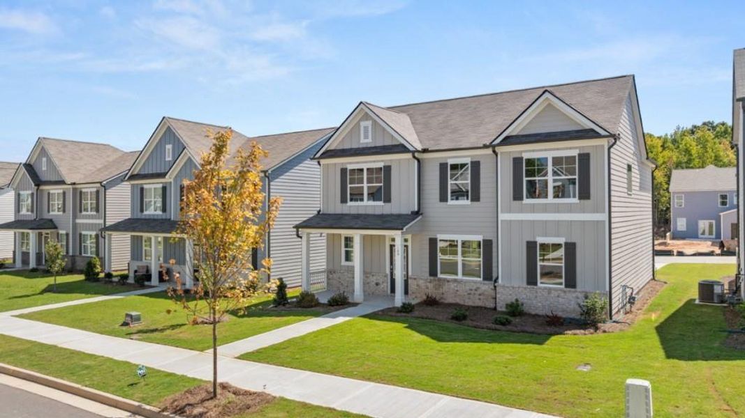 Front exterior of a new home in Braselton Village, Braselton, GA, highlighting curb appeal (Image 2). Front exterior of a new home in Braselton Village, Braselton, GA, highlighting curb appeal (Image 2).