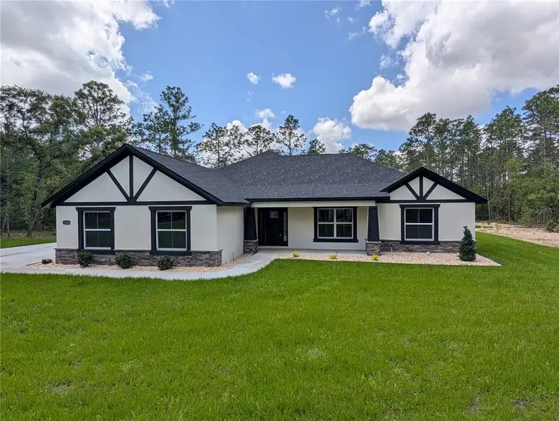Front exterior of a new home in , Dunnellon, FL, highlighting curb appeal (Image 2). Front exterior of a new home in , Dunnellon, FL, highlighting curb appeal (Image 2).