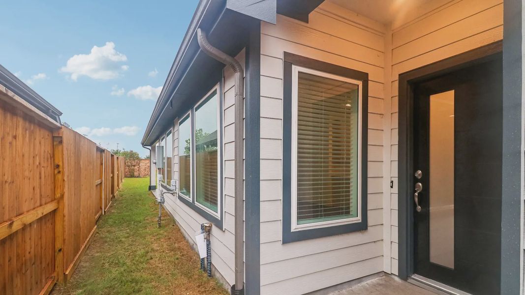 Exterior details and patio area of a home in Meridiana Townhomes, Manvel (Image 4).