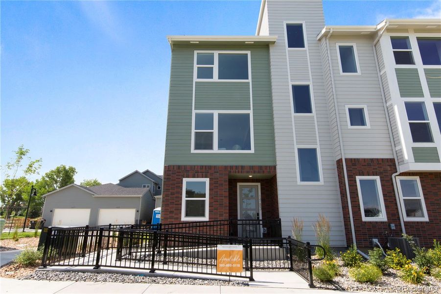 Front exterior of a new home in Dillon Pointe - Skyview, Broomfield, CO, highlighting curb appeal (Image 1).