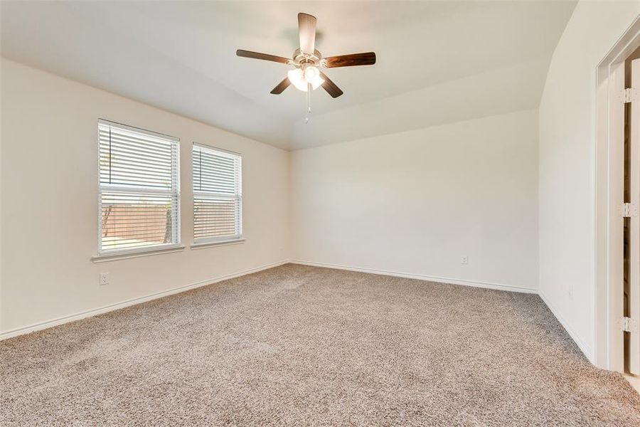 Unfurnished living room featuring light wood-type flooring, ceiling fan, and vaulted ceiling Unfurnished living room featuring light wood-type flooring, ceiling fan, and vaulted ceiling