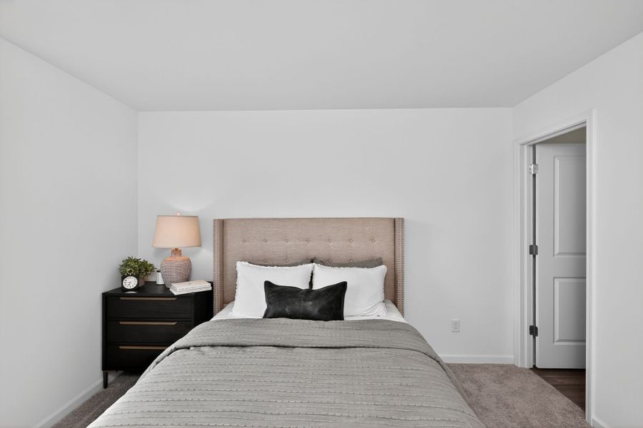 A bed with a lamp on the side.