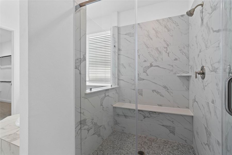 The walk-in shower includes a convenient, integrated bench with a niche shelf, offering comfort, extra storage space, and a high-end, custom appearance. The walk-in shower includes a convenient, integrated bench with a niche shelf, offering comfort, extra storage space, and a high-end, custom appearance.