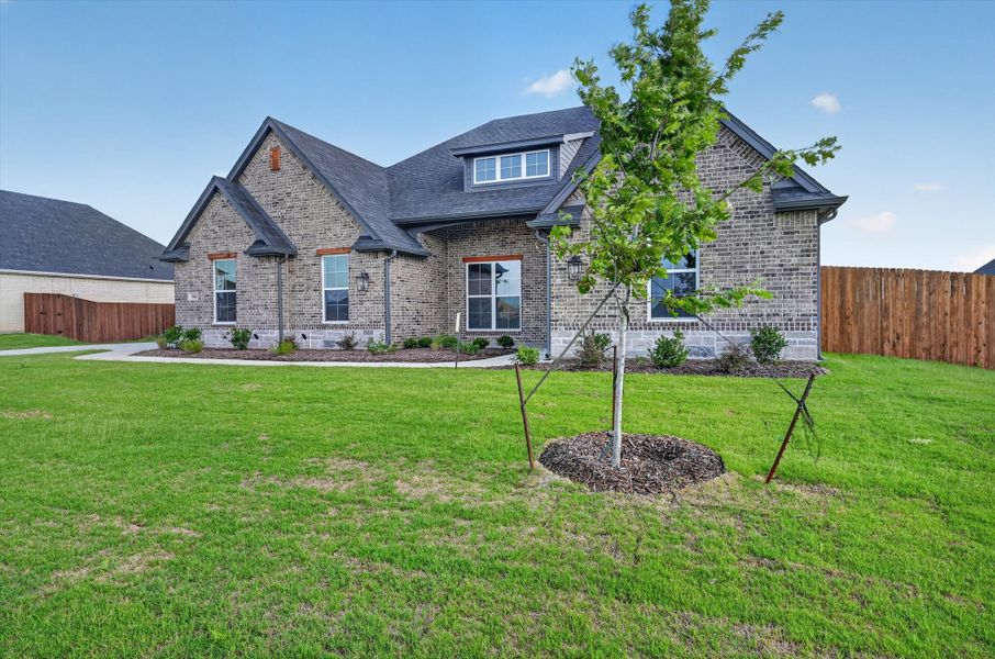Front exterior of a new home in Coyote Crossing, Godley, TX, highlighting curb appeal (Image 20). Front exterior of a new home in Coyote Crossing, Godley, TX, highlighting curb appeal (Image 20).