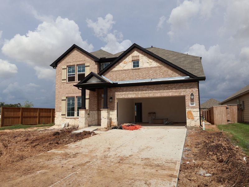 Front exterior of a new home in Summerview, Fulshear, TX, highlighting curb appeal (Image 20). Front exterior of a new home in Summerview, Fulshear, TX, highlighting curb appeal (Image 20).