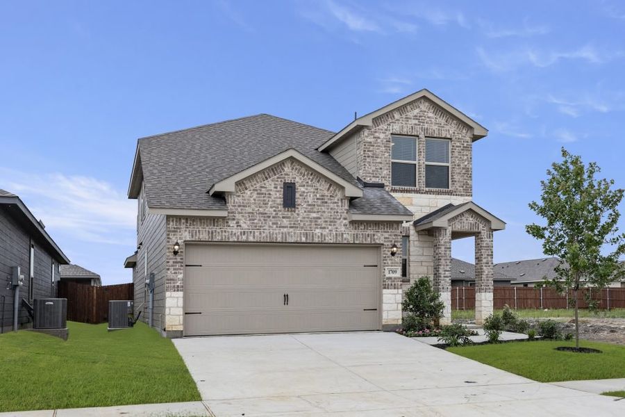 Representative exterior photo of a completed home built from the Willow by Impression Homes in Creekside Ranch, Blue Ridge, TX (Image 2).