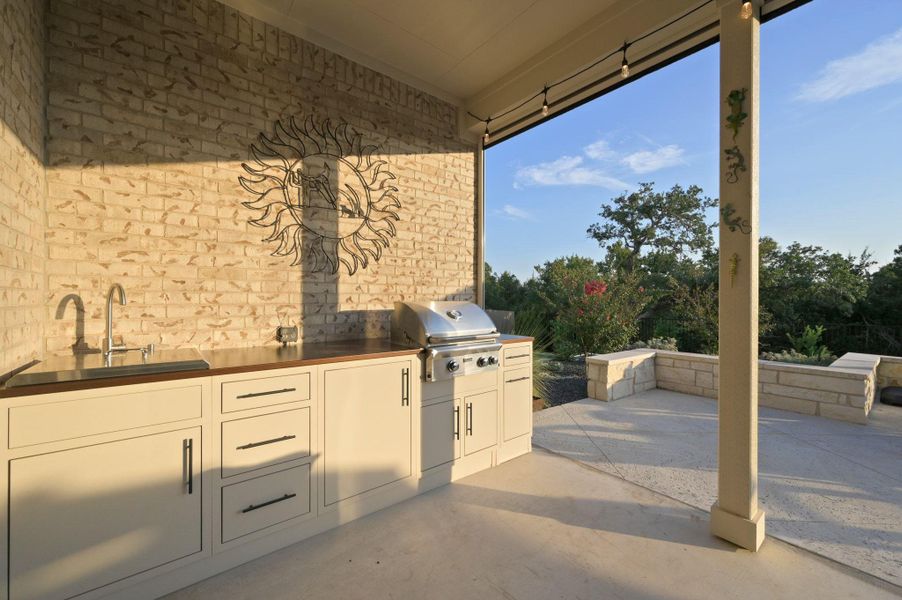 The outdoor kitchen, complete with a sink and gas grill, makes hosting friends and family effortless The outdoor kitchen, complete with a sink and gas grill, makes hosting friends and family effortless