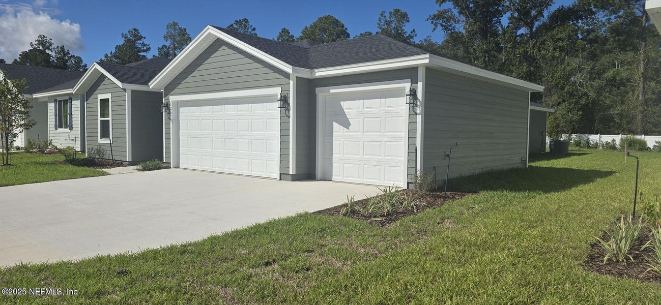 Front exterior of a new home in Azalea Creek, Jacksonville, FL, highlighting curb appeal (Image 12).