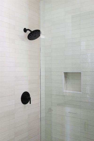 Bathroom featuring decorative backsplash, dual vanities and designer fixtures.