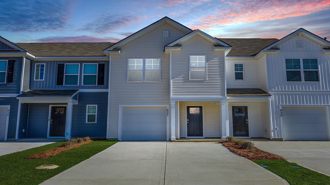 Front exterior of a new home in Pine Hills Townhomes at Cane Bay, Summerville, SC, highlighting curb appeal (Image 1). Front exterior of a new home in Pine Hills Townhomes at Cane Bay, Summerville, SC, highlighting curb appeal (Image 1).