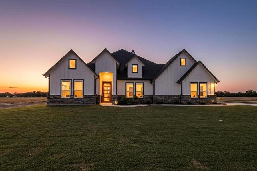 Modern inspired farmhouse featuring board and batten siding and a lawn Modern inspired farmhouse featuring board and batten siding and a lawn