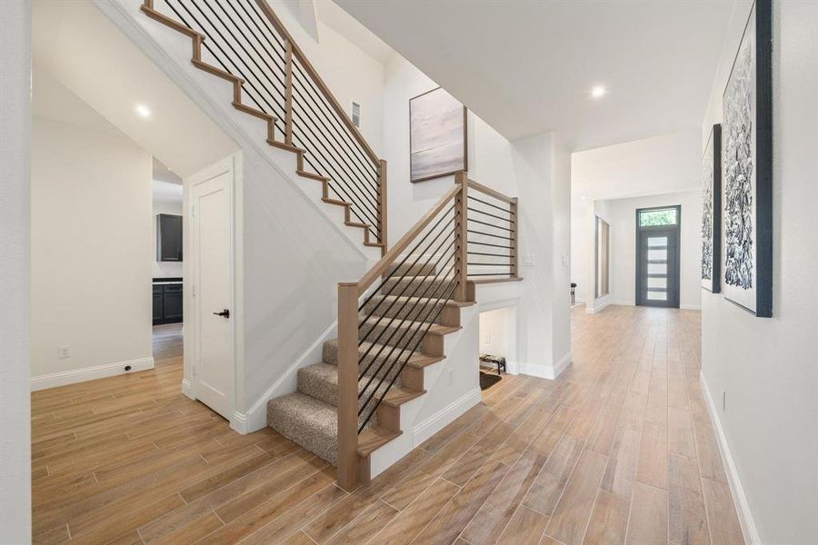 Stairs featuring wood finish floors and recessed lighting Stairs featuring wood finish floors and recessed lighting