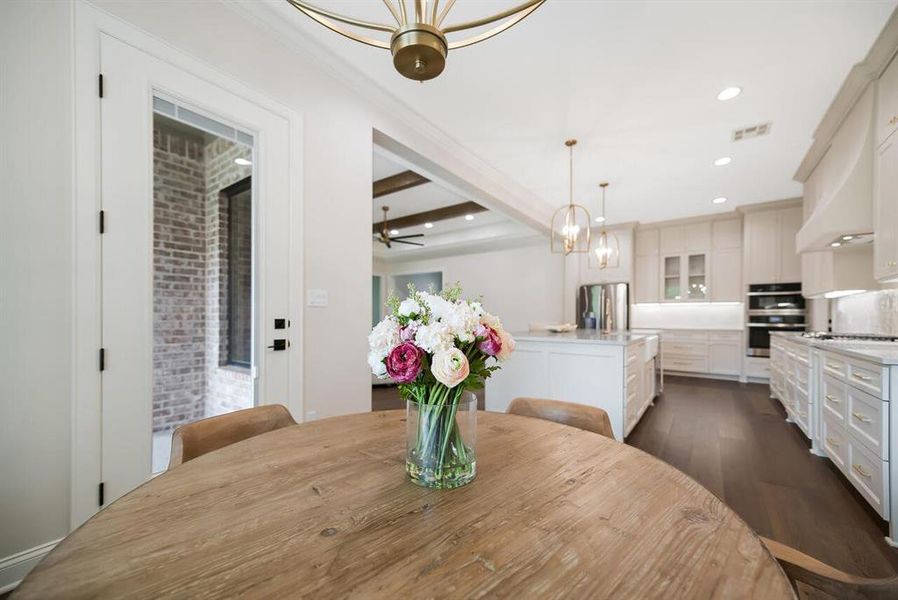 Dining room featuring dark wood-type flooring, a chandelier, beam ceiling, recessed lighting, and crown molding Dining room featuring dark wood-type flooring, a chandelier, beam ceiling, recessed lighting, and crown molding