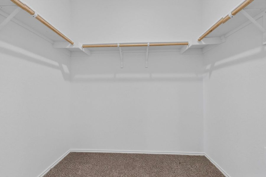Generous closet space features wrap-around shelving, hanging rods, and soft carpeting underfoot. Generous closet space features wrap-around shelving, hanging rods, and soft carpeting underfoot.