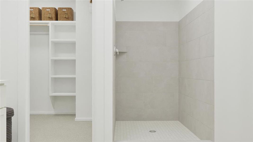 Bathroom featuring a stall shower and a spacious closet Bathroom featuring a stall shower and a spacious closet