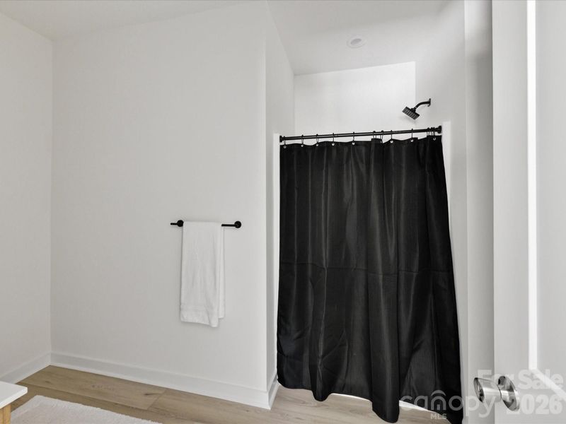 Primary bath shower with modern fixtures and a clean, minimalist design offering a relaxing retreat. Primary bath shower with modern fixtures and a clean, minimalist design offering a relaxing retreat.