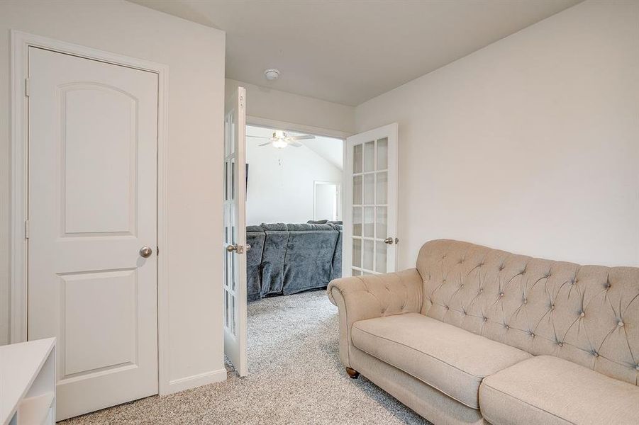 Sitting room with carpet, french doors, and a ceiling fan