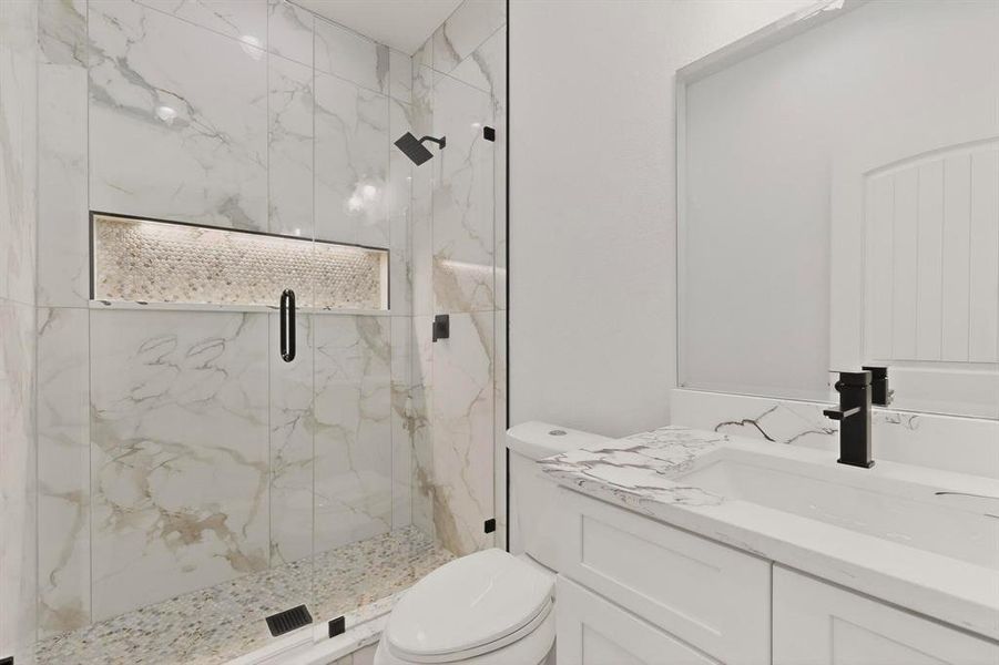 Full bathroom featuring vanity and a marble finish shower Full bathroom featuring vanity and a marble finish shower