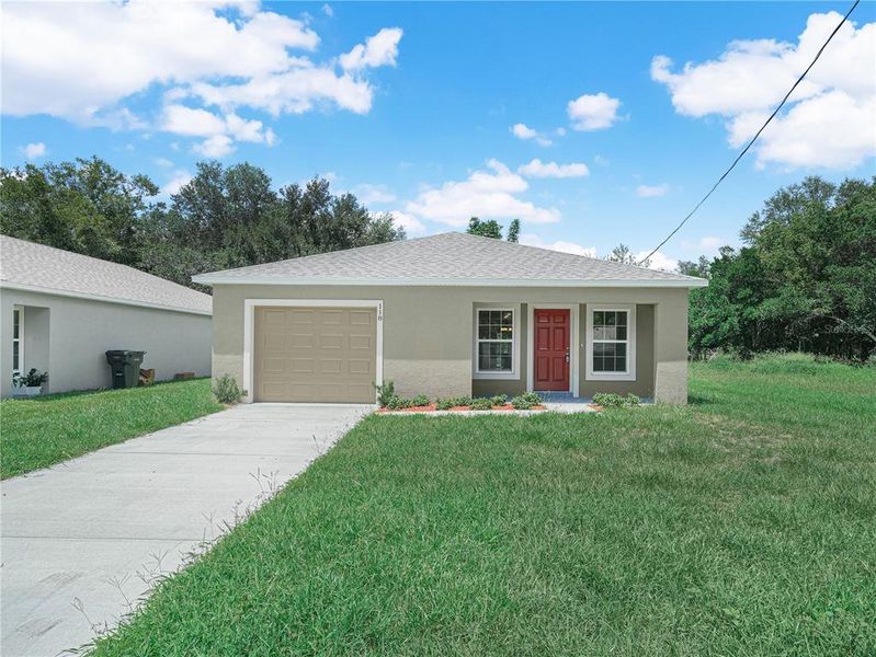 Front exterior of a new home in , Auburndale, FL, highlighting curb appeal (Image 1). Front exterior of a new home in , Auburndale, FL, highlighting curb appeal (Image 1).