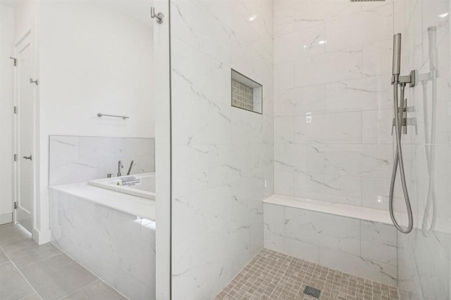 Bathroom with a garden tub, a marble finish shower, and tile patterned floors Bathroom with a garden tub, a marble finish shower, and tile patterned floors