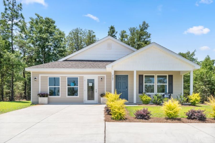 A house with a driveway with Little White House in the background.