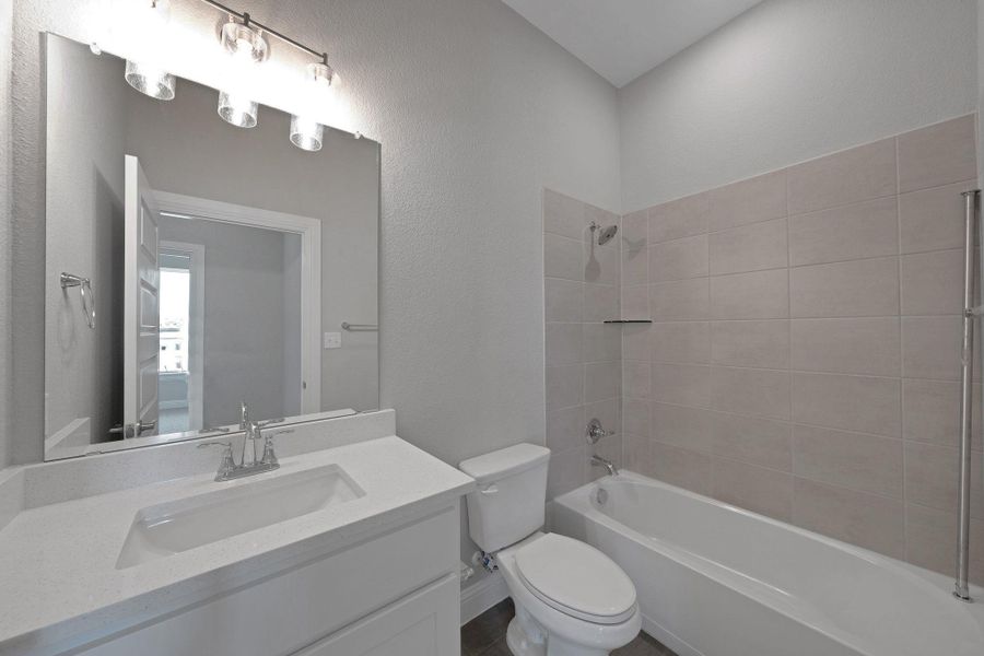 Bathroom featuring vanity and shower / bath combination Bathroom featuring vanity and shower / bath combination