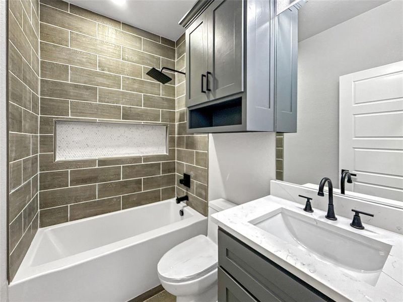 Full bath featuring tub / shower combination and vanity
