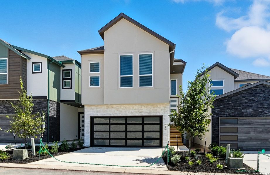 Front exterior of a new home in Centero at Stone Oak, San Antonio, TX, highlighting curb appeal (Image 20).