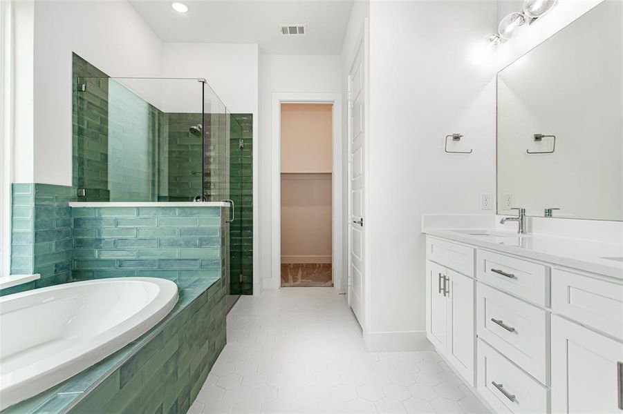 Bathroom featuring vanity, separate shower and tub, and tile patterned flooring