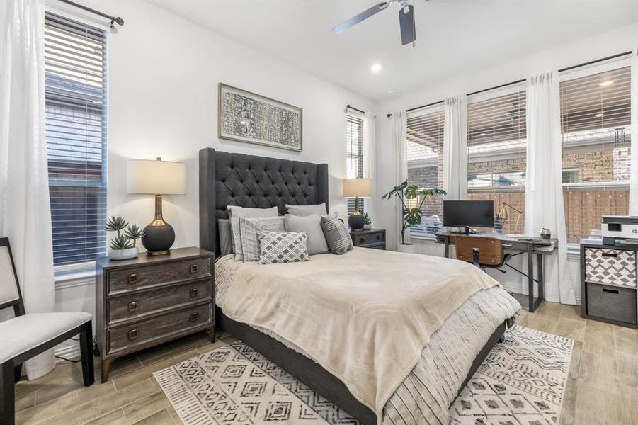 Bedroom with wood finish floors, a ceiling fan, recessed lighting, and a desk Bedroom with wood finish floors, a ceiling fan, recessed lighting, and a desk
