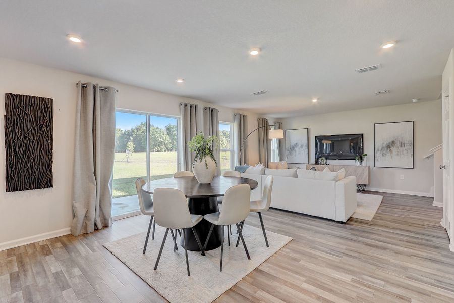 A large room with a table and chairs.