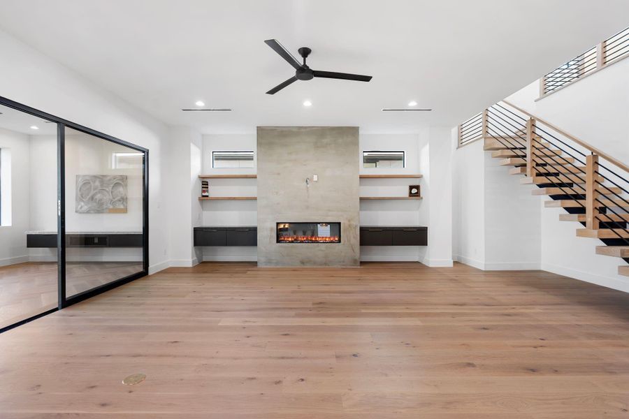 Living Room - Stucco Fireplace, Floating Cabinets with lighting.