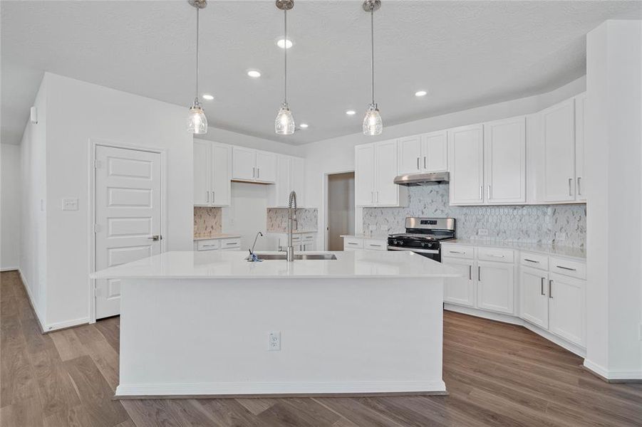 This kitchen is by far any chef’s dream! This spacious kitchen features high ceilings, stained wood cabinets, silestone countertops, SS appliances, modern tile backsplash, recessed and pendant lighting, extended counter space, silestone kitchen island single sink and space for breakfast bar, and a walk-in pantry all overlooking your huge family room.