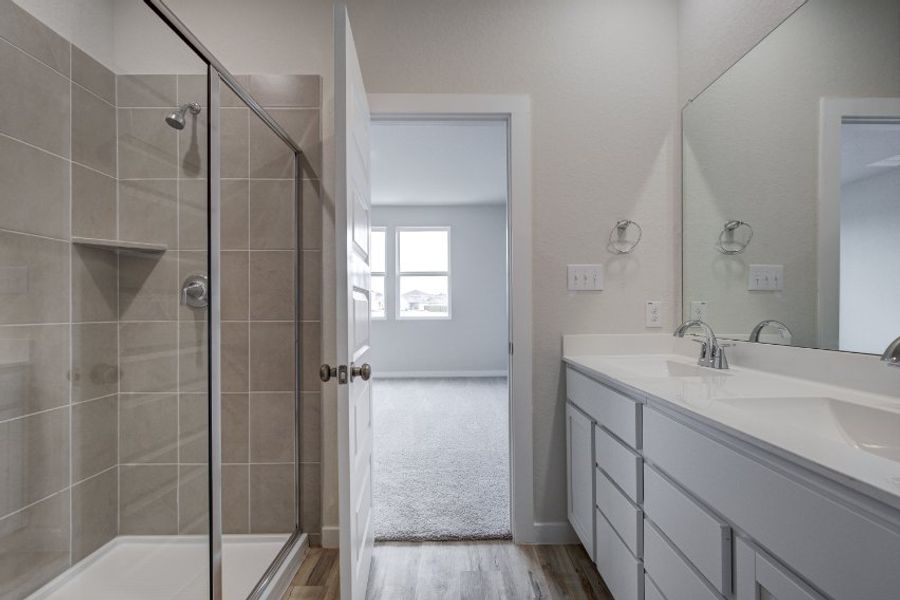 A bathroom with a glass shower. A bathroom with a glass shower.