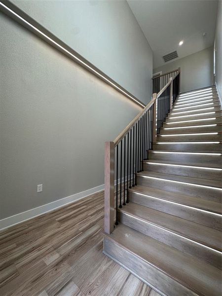 Stairway with hardwood / wood-style floors