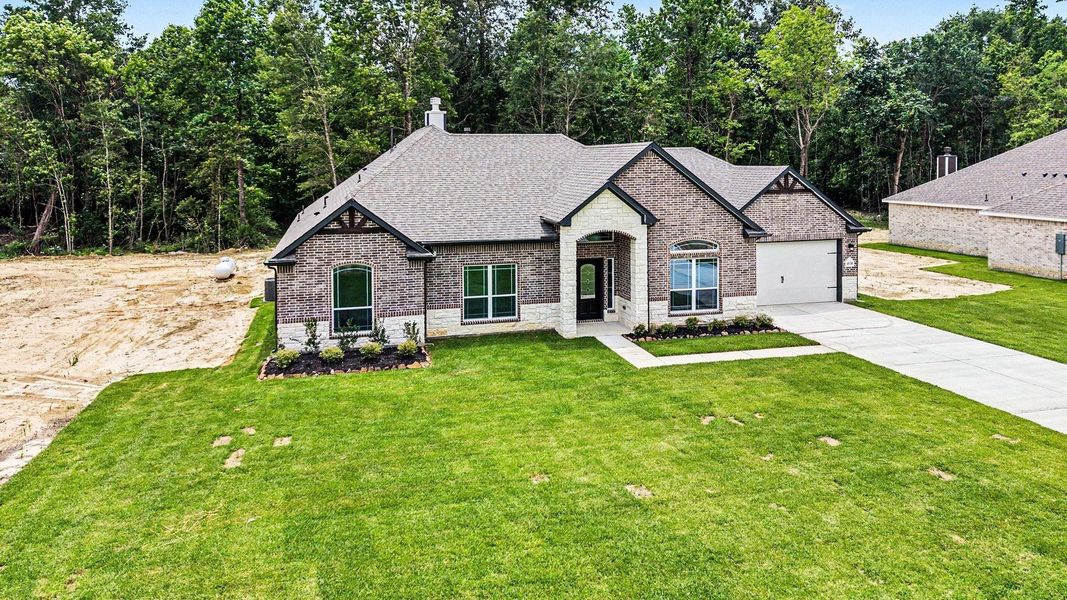 Front exterior of a new home in Encino Estates, Dayton, TX, highlighting curb appeal (Image 24). Front exterior of a new home in Encino Estates, Dayton, TX, highlighting curb appeal (Image 24).