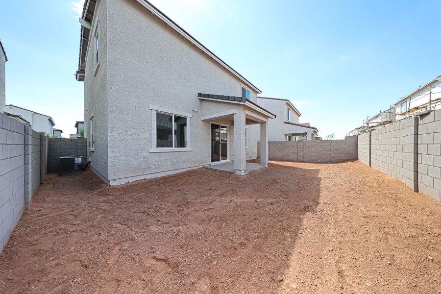 A dirt road between buildings.