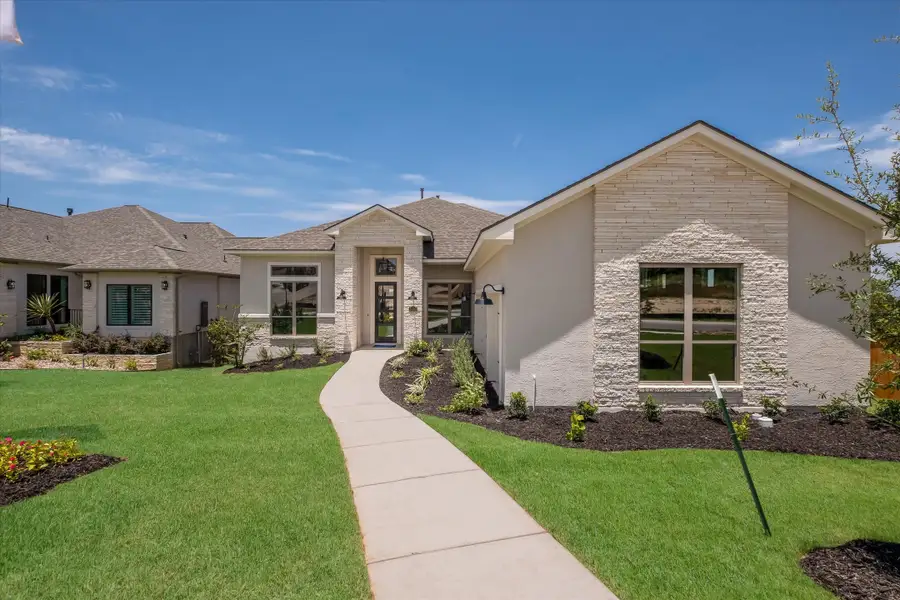 Front exterior of a new home in Johnson Ranch, Bulverde, TX, highlighting curb appeal (Image 2).