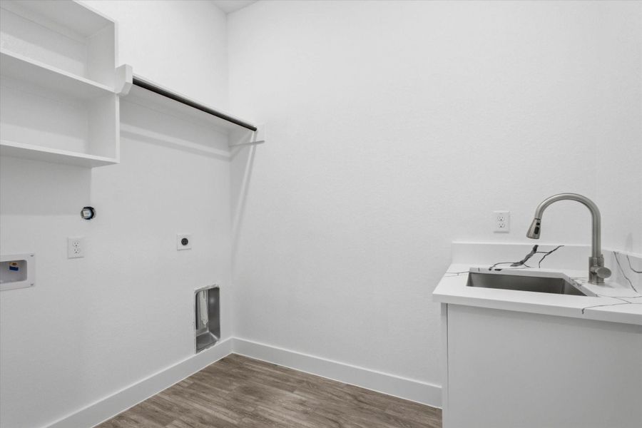The downstairs laundry room comes complete with built-in storage and a utility sink for added convenience. The downstairs laundry room comes complete with built-in storage and a utility sink for added convenience.