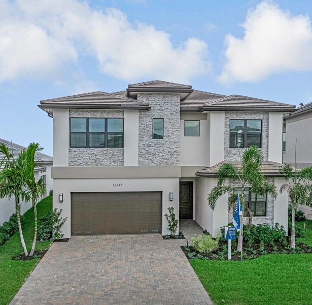 Front exterior of a new home in Apex at Avenir, Palm Beach Gardens, FL, highlighting curb appeal (Image 21).