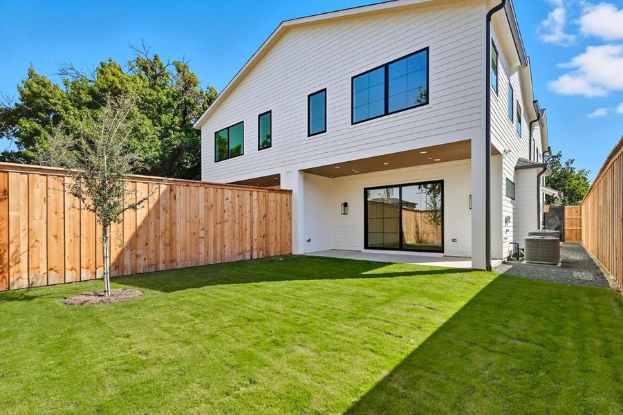 Rear view of house with a patio area and a fenced backyard Rear view of house with a patio area and a fenced backyard
