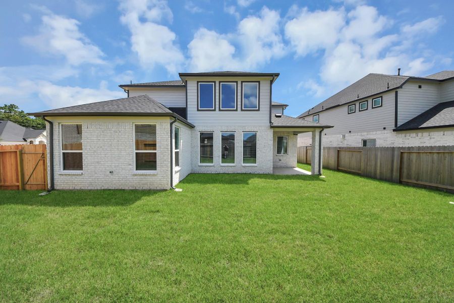 Step into a world of outdoor possibilities with this remarkable backyard and its charming covered patio. From playtime for the kids to relaxation for the adults, this space offers the best of both worlds. Customize it with patio furniture, a BBQ pit, and more, turning it into the ultimate outdoor retreat that suits your lifestyle