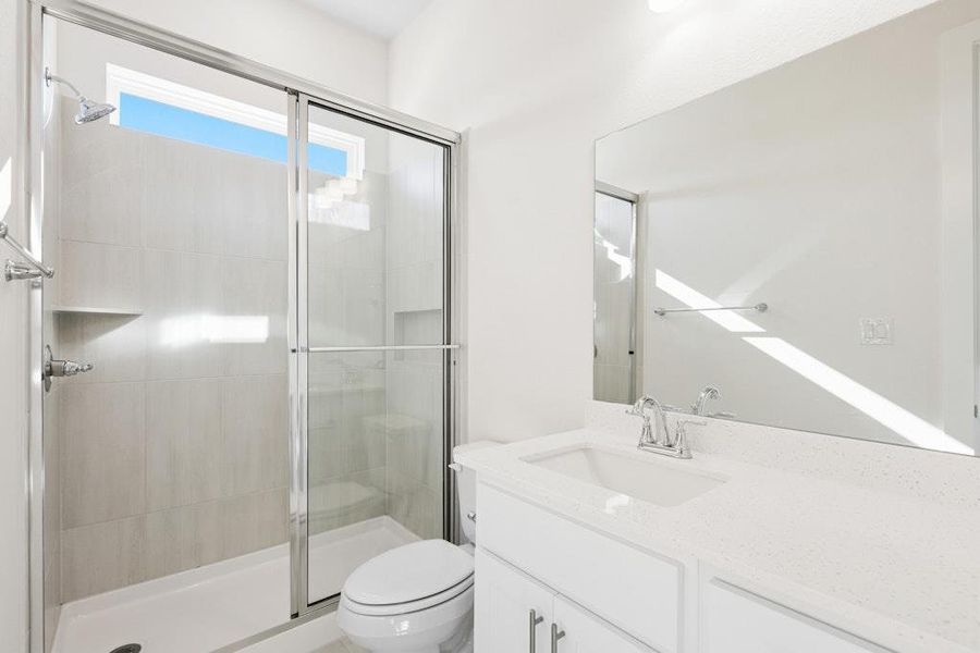 Full bath featuring vanity and a shower stall Full bath featuring vanity and a shower stall