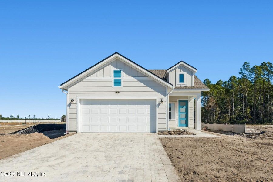 Front exterior of a new home in Evergreen Island at Silverleaf - Classic, St. Augustine, FL, highlighting curb appeal (Image 1). Front exterior of a new home in Evergreen Island at Silverleaf - Classic, St. Augustine, FL, highlighting curb appeal (Image 1).