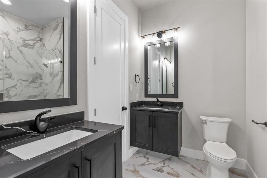 Bathroom with tile patterned floors, vanity, and toilet