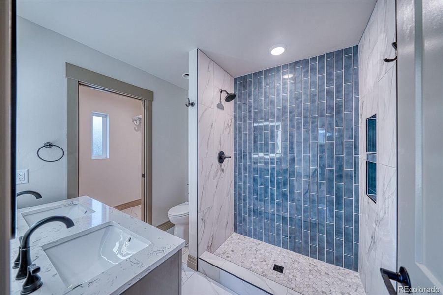 En suite in the primary. Large shower and dual sinks makes this an ideal primary bathroom.